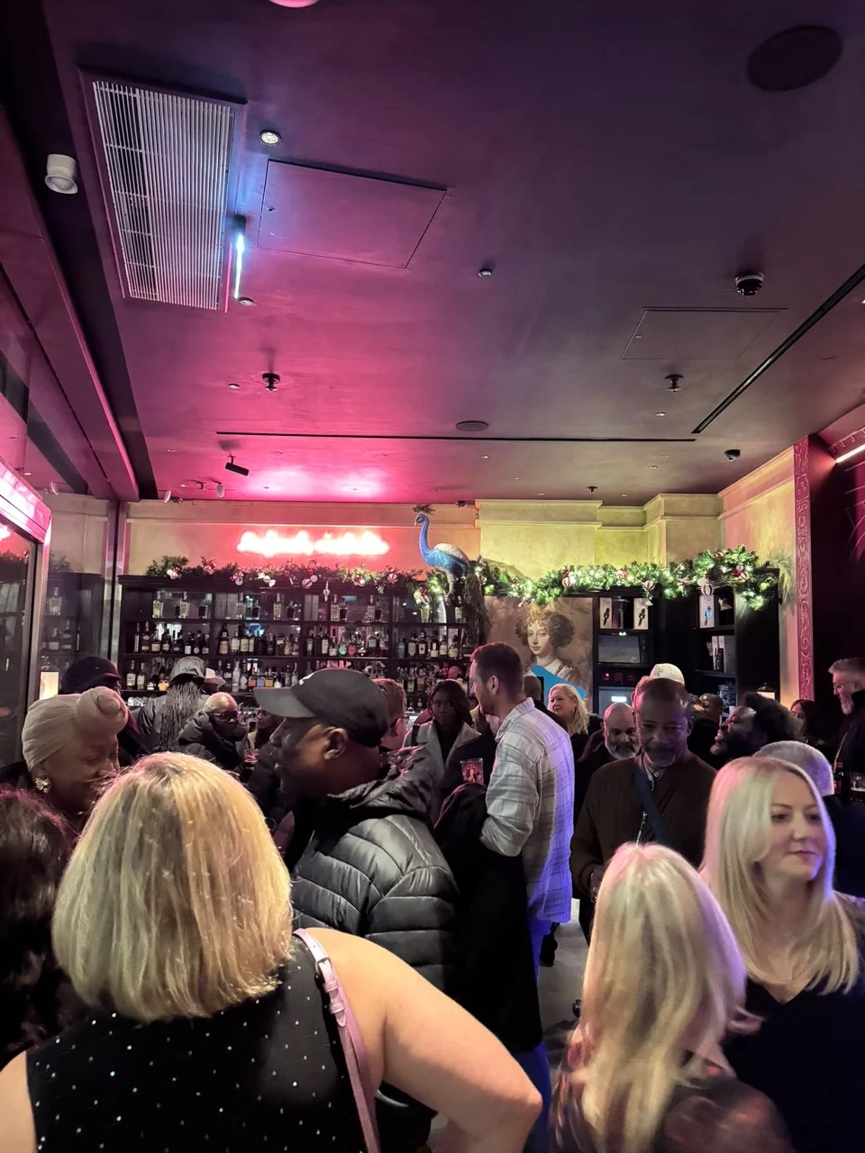 A crowd gathered inside a lively event venue
